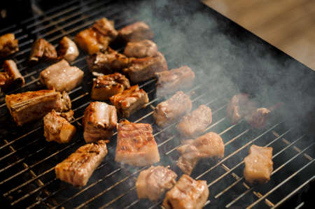 Large delicious juicy meat pieces on the grill grate. Man cooking a very tasty shashlikの写真素材