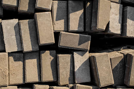 Top view texture background fo wallpaper of randomly scattered grey building bricks under the sun lightの写真素材