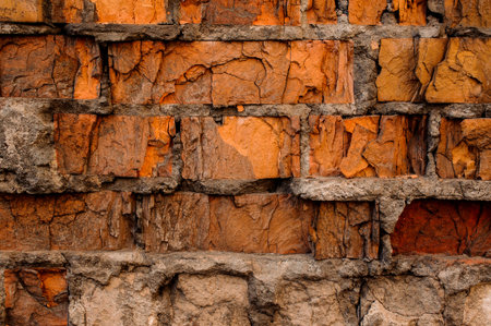 Cracked concrete vintage red brick wall background. Rustic bricks texture wall. Old industrial...