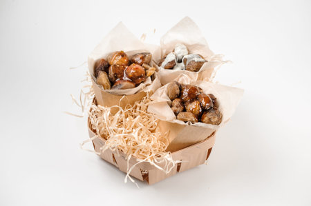 Isolated set of three paper packs with tasty chestnuts with sauce on bright white studio background