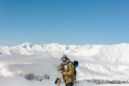 The man in the goggles from the sun reflecting mountain landscape.の写真素材