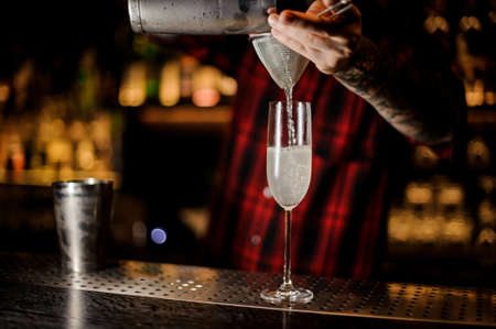Barman making a fresh and tasty French 75 cocktailの写真素材
