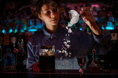 Female bartender empty cocktail glass from ice