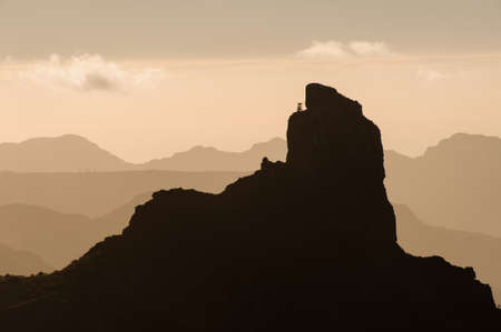 GRAN CANARIA, SPAIN - Top point of Roque Nublo mountain under the yellow sky with cloudsの写真素材