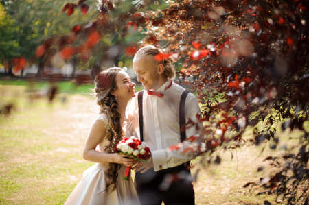 Smiling married couple walking in a green parkの写真素材