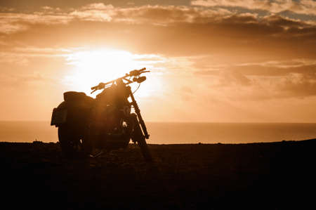 Motorcycle silhouette in the background of bright sunset in Spainの写真素材