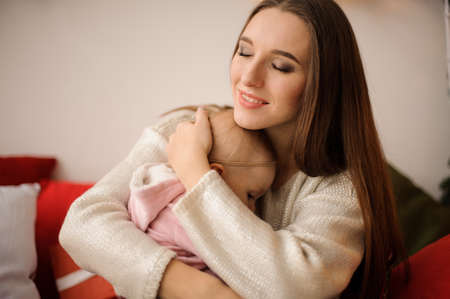 Woman hugging her cute little daughter on handsの写真素材
