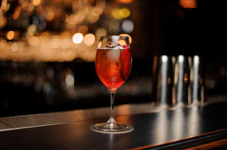 Red cocktail in glass on a bar counterの写真素材