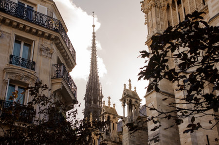 FRANCE, PARIS - OCTOBER 20, 2017: Tower of the Notre Dame de Paris cathedral in the day under the...
