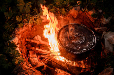 Close-up of the pot on camp fireの写真素材