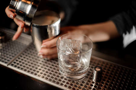 Close-up of shaker and glass with iceの写真素材