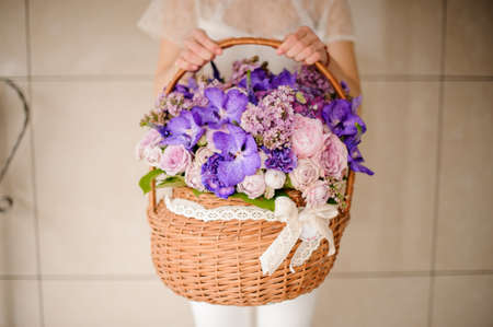 Close shot of large basket with purple flowersの写真素材