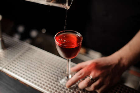 Cherry falls in a drink from special tongsの写真素材