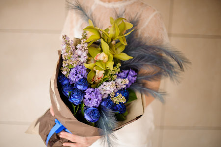 Close shot of amazing bouquet with blue flowers and feathersの写真素材