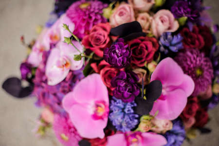 Close up box of tender pink, violet and blue flowersの写真素材