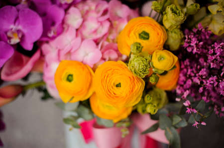 Close up spring white box of tender yellow, green and pink flowersの写真素材