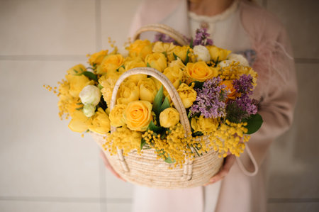 Lush bouquet of yellow flowers in basketの写真素材