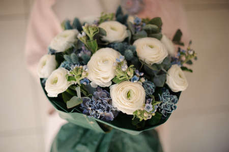 Close shot of bouquet in dark green wrappingの写真素材