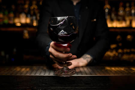 Close-up of splashing alcohol cocktail in bartenders handsの写真素材