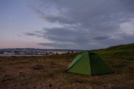 Green tent standing on the hill in springの写真素材