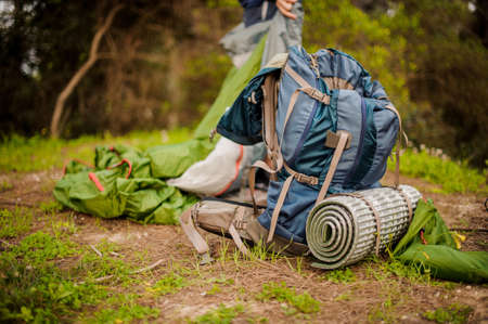 Backpack and other hiking equpment on the groundの写真素材
