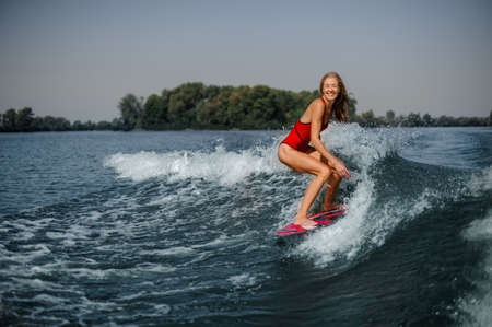 Girl in swimsuit on a board in seaの写真素材