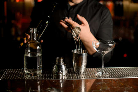Close-up of pouring cocktail with a shakerの写真素材