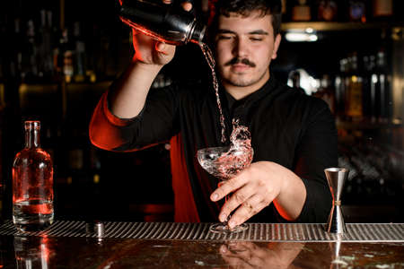 Bartender making an alcohol drink with shakerの写真素材