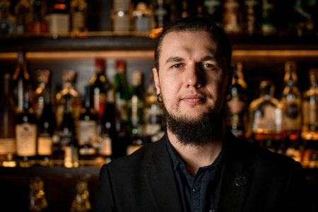 Portrait of adult male bartender in bar