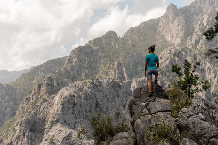 Young girl standing on top of the mountainの写真素材