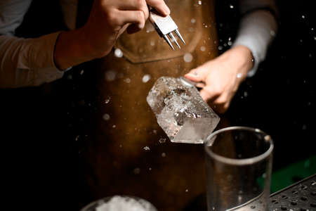 Male bartender making a crushed with a special instrumentの写真素材