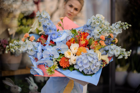 Girl holding big bouquet of blue flowersの写真素材