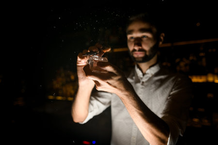 Bartender crushes ice with an ice crusher