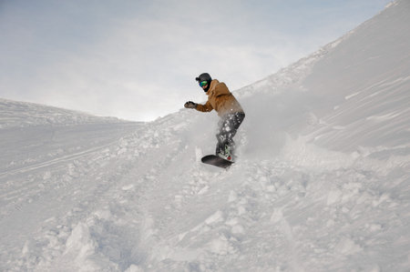 Disabled man without one hand riding on the snowboard