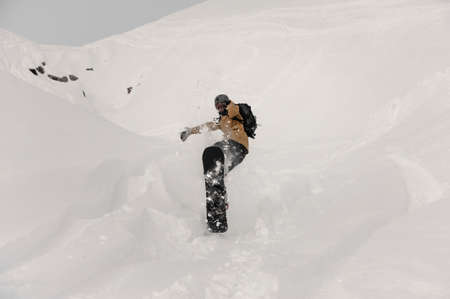 Paralympic snowboarder making a jump trick on the white snow covered hillの写真素材