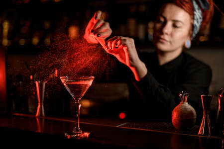 Close shot of bartender making cocktail with citrus zestの写真素材