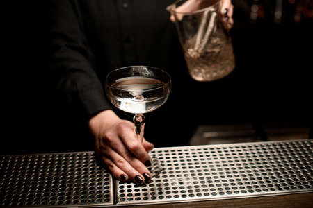 Close-up of alcohol cocktail in bartenders handの写真素材