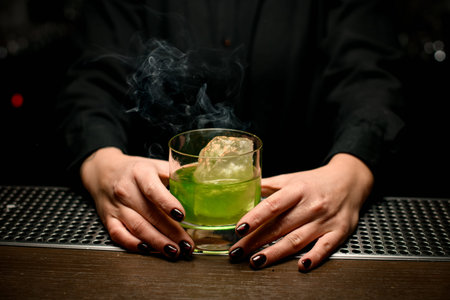 Close-up of smoking cocktail in bartenders handsの写真素材