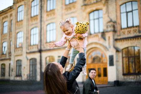 Mother playing with daughter holding her in the arms up