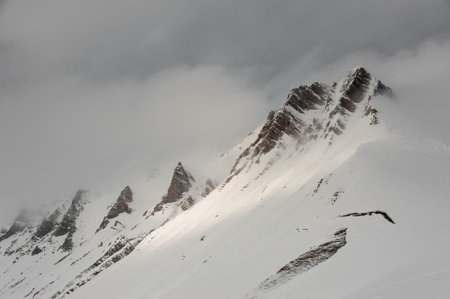 Landscape of mountain tops in cloudy weather