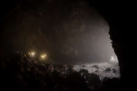 Beautiful landscape cave in a large rock with water on stonesの写真素材