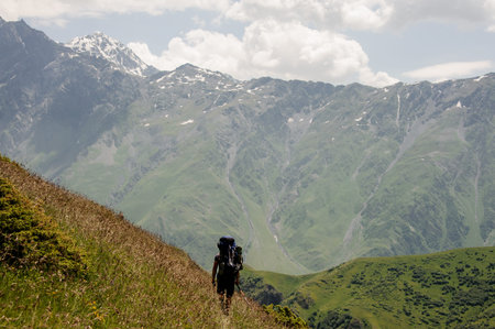 Prepared tourist walking in the high mountains