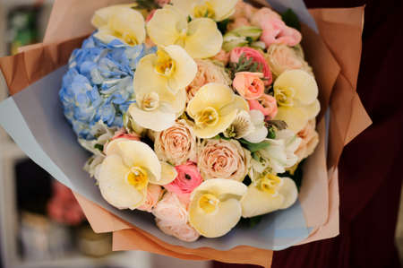 Lush bouquet with orchids, roses and poppiesの写真素材
