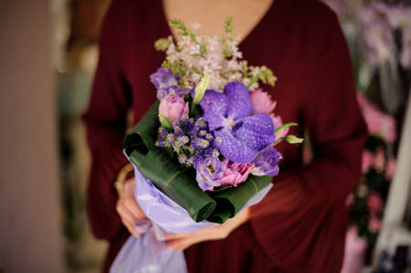 Close-up of woman with a bouquet with irisの写真素材