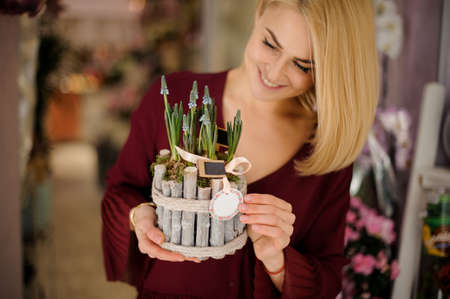 Blond girl with decorated sprouts of bluebellsの写真素材