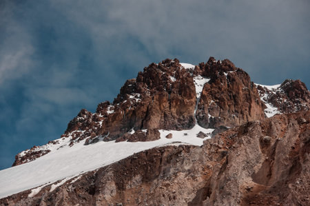 Mountain rocky hill with the snow remnants