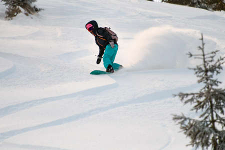 Human slips down a snow covered steep slopeの写真素材