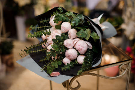 Bouquet of peonies laying on glass tableの写真素材