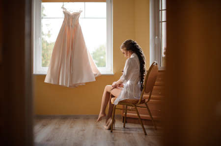pretty girl is going to wear a beautiful pink dressの写真素材