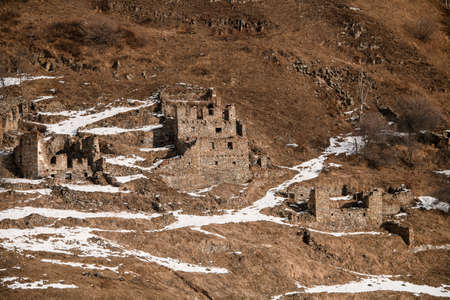 Old antique abandoned city in winter mountains.の写真素材